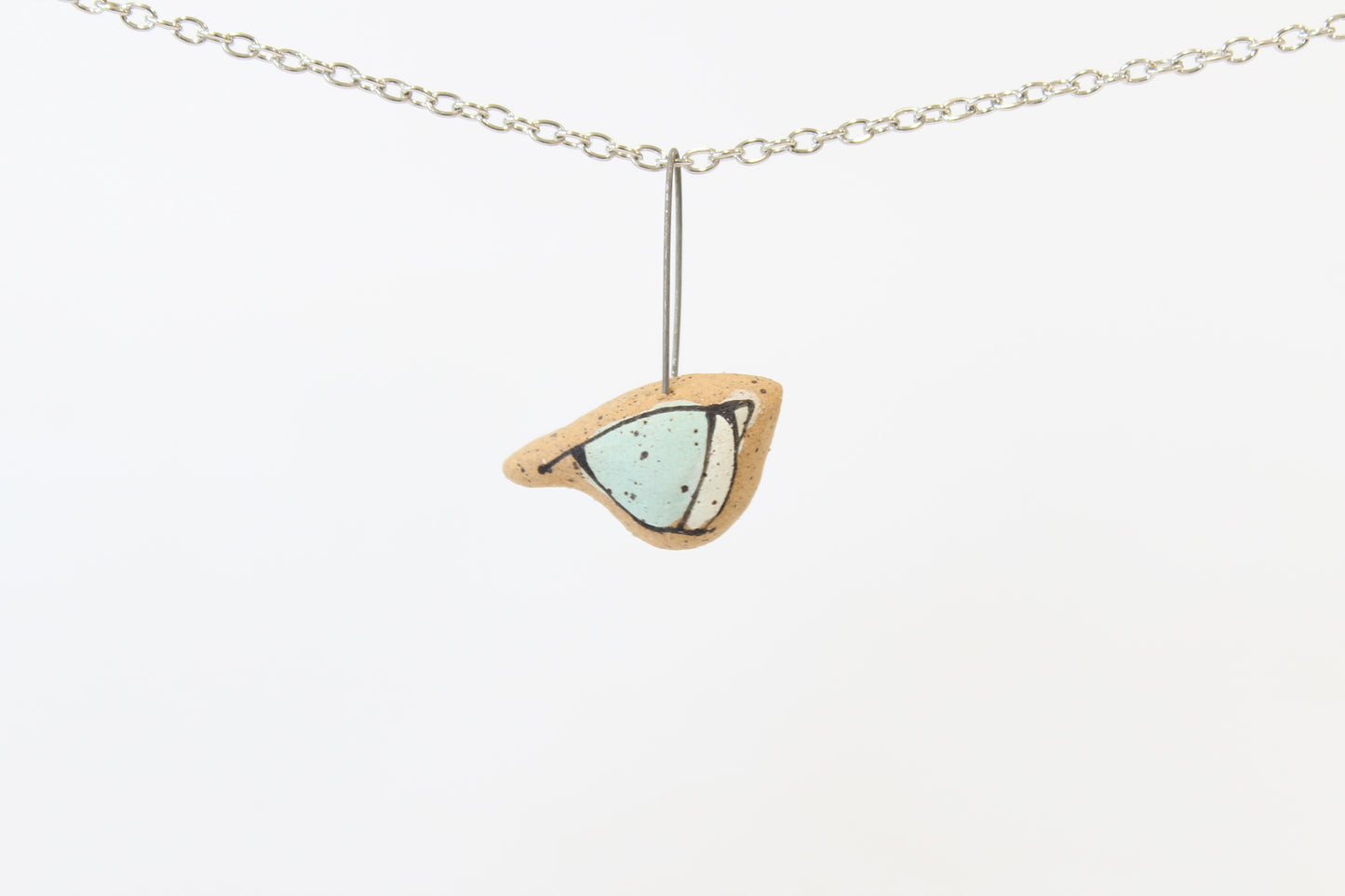 1071. Light Blue Underglaze Bird Necklace - 1" x 1"
